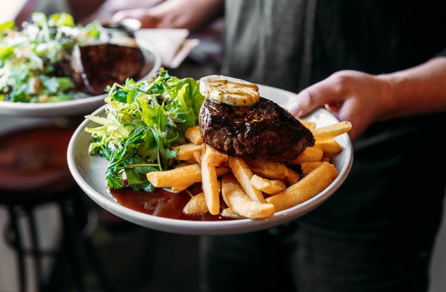 Steak and chips on a plate.