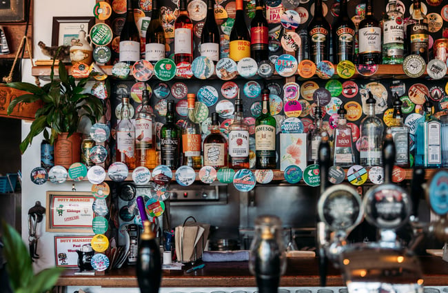 Beer stickers on a wall behind the bar at Atlas Beer Cafe Queenstown.