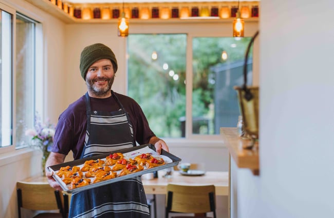 Chef with tray of pastries at Augustines of Portobello.