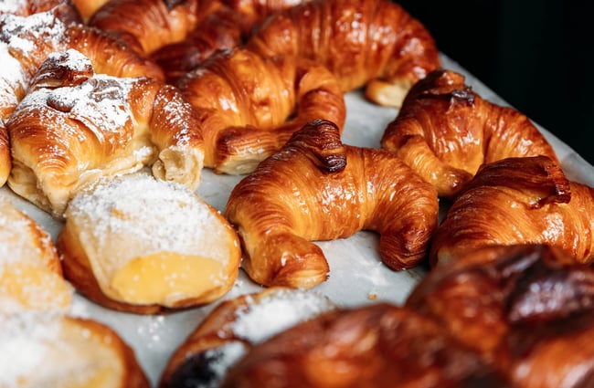 Tray of croissants and other pastries at Aurora Argentinian Bakery.