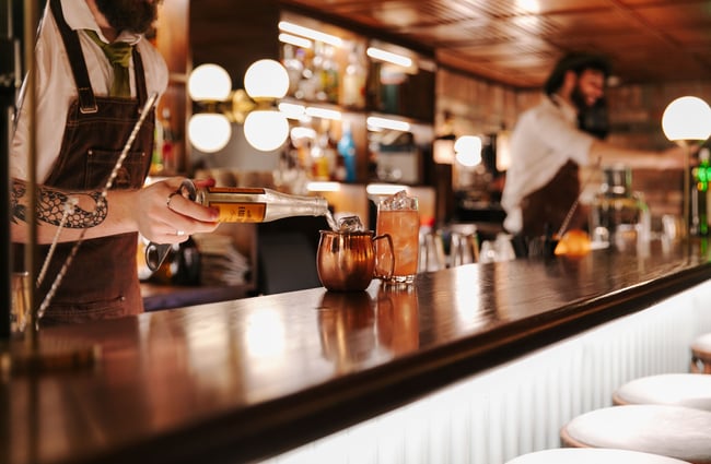 Barman making a cocktail with ginger ale at Austin Club in Christchurch.