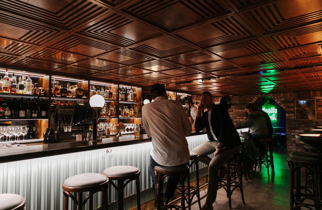 Patrons sitting on stools at Austin Club in Christchurch.