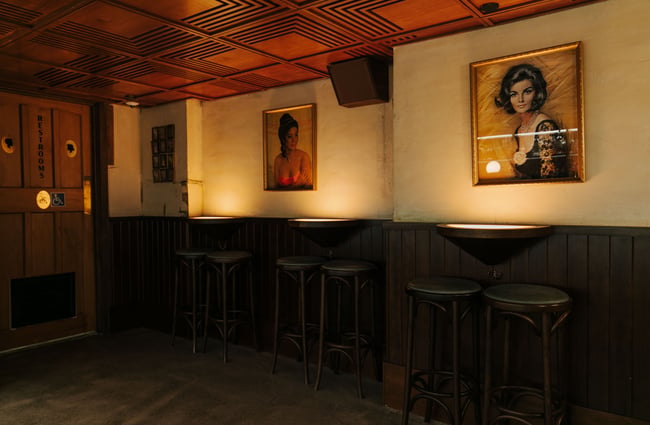 Vintage artwork on the wall in the seating area at Austin Club in Christchurch.