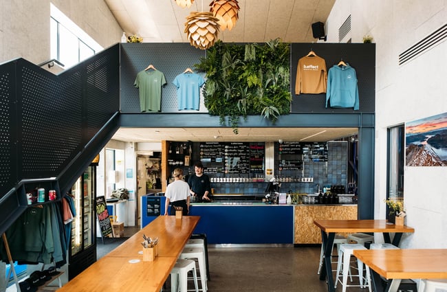 A woman is served at the counter of b.social.