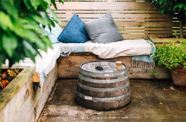 Corner couch with blue throw cushions.