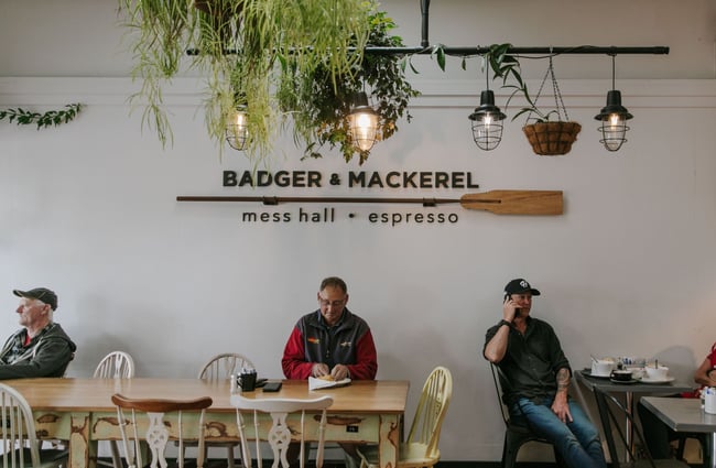 Customer at big table at Badger and Mackerel in Ōamaru.