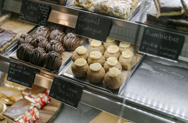 The glass food cabinet with two different flavours of bliss balls inside.