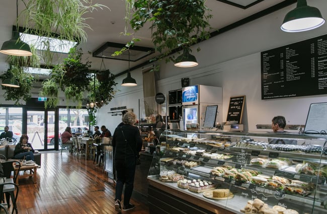 A person ordering at the Badger & Mackerel counter.
