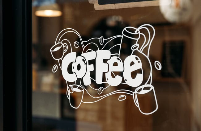 A coffee sign on a window.