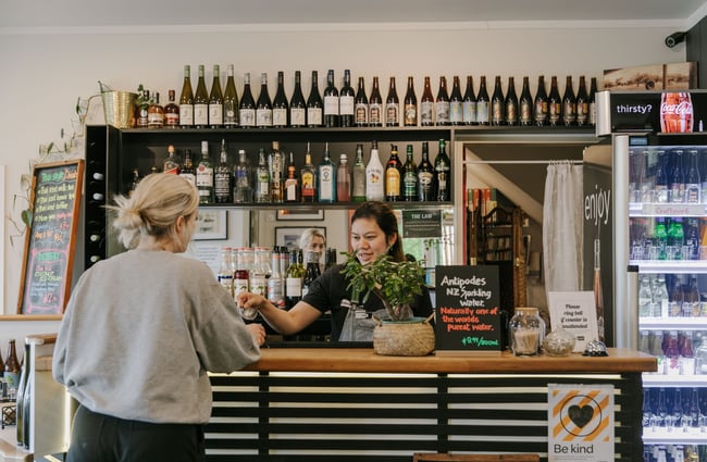 A customer being served by a waitress at the counter.
