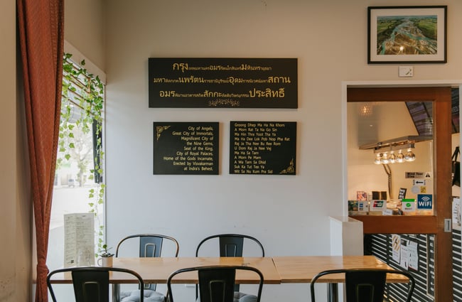 A dining table and chairs inside the restaurant at Bangkok Recipe.