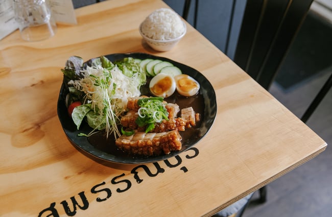 A close up of a plate of Thai food on a table at Bangkok Recipe Oamaru.