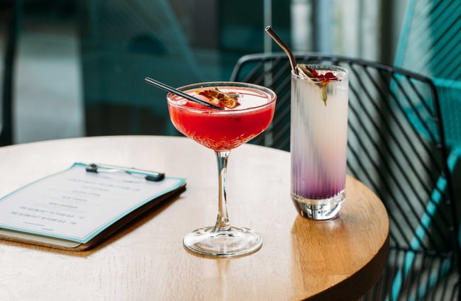 Two of the Banh Mi cocktails, one in a tall tumbler and one in a coupe glass.