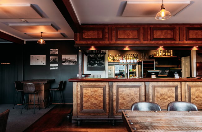 A large wooden bar counter inside a restaurant.