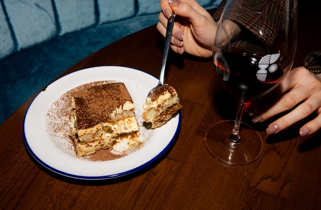 Tiramisu and a glass of wine on the table at Bar Franco.