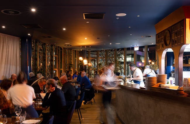 Busy dining room and open kitchen at Bar Franco.