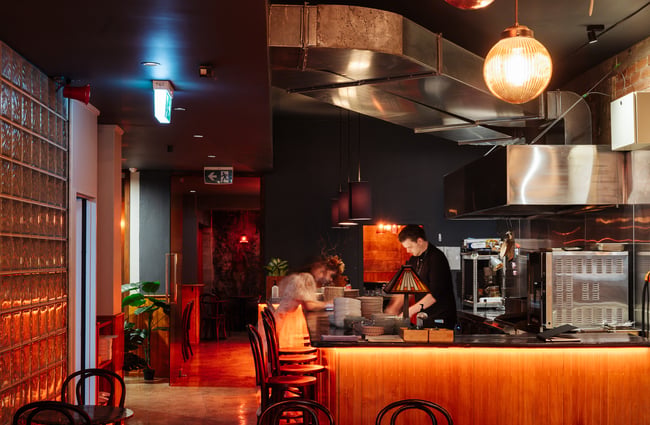 A staff member working behind the bar at Bar Magda.