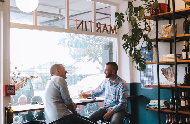 Two men catching up over a drink at Bar Martin, Auckland.