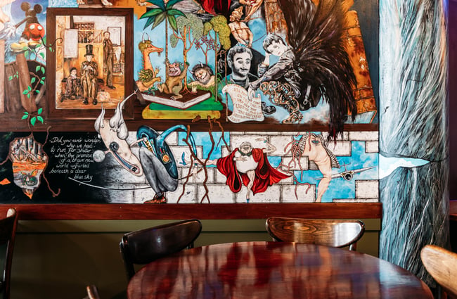 Artwork on the wall behind the table at Barista.