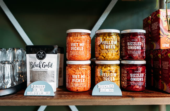 Pantry items arranged on a shelf for sale at Barista.