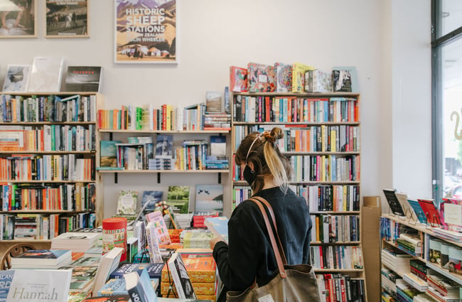 Woman browsing books at Bay Hills Books in Timaru, New Zealand.