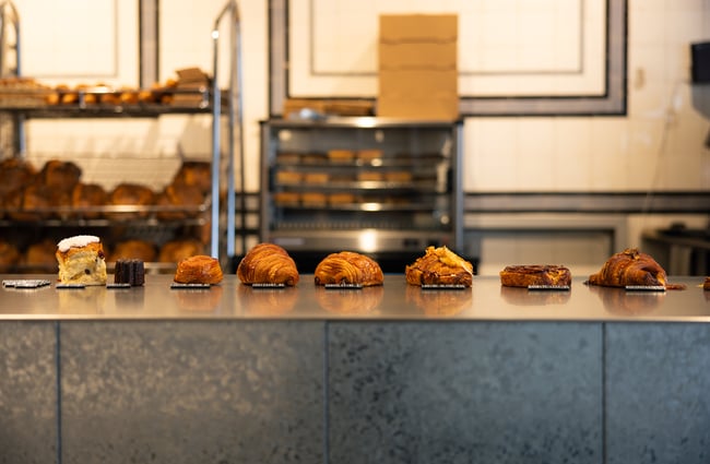 Pastries lined up in a row on a counter top.