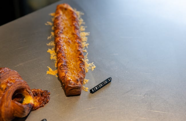 A cheesy baked pastry on a counter.