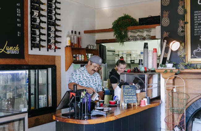 Two people behind the counter at Beach House Cafe.