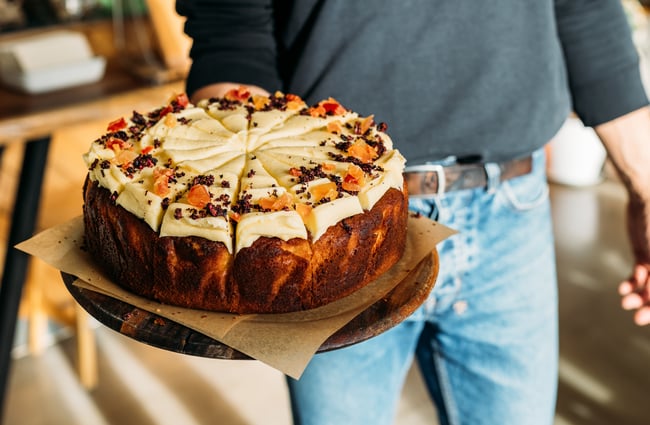 A close up of a carrot cake sliced up.