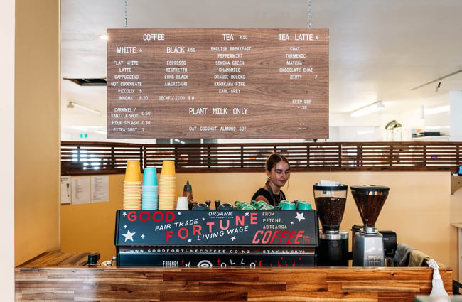 Barista at coffee machine at Belen Plant Bakery in Petone