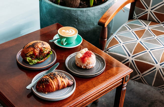 Baked goods and coffee on small table at Belen Plant Bakery in Petone