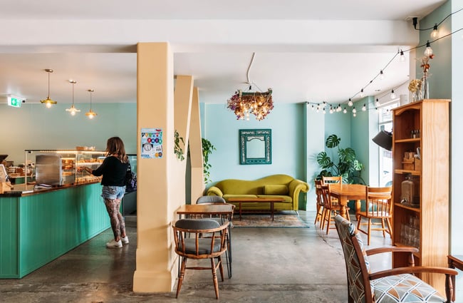 Interior of Belen Plant Bakery with eclectic furniture and retro couch