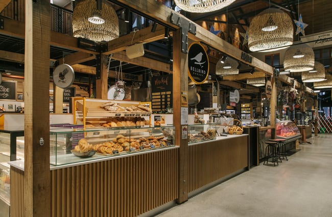 A cafe counter inside a large indoor market.