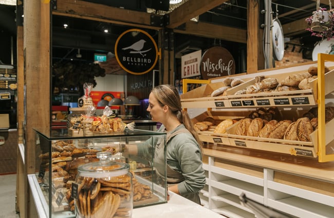 A woman working behind a cafe counter.