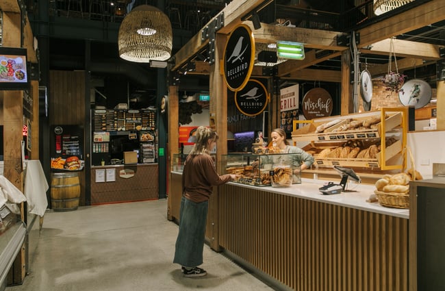 A customer being served at Bellbird Bakery in Riverside Market.