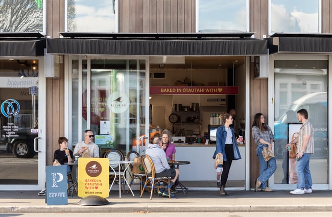 Customers sitting at tables outside Bellbird Bakery Holmwood.