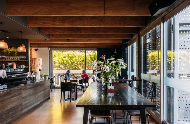A long wooden table in a cafe.
