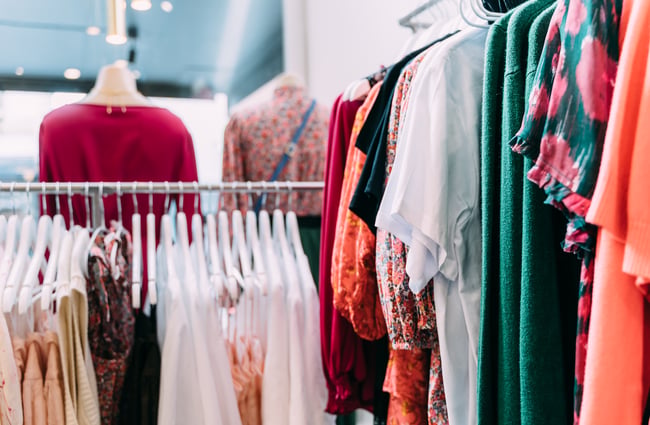 Racks of clothing for sale at Belle Bird Boutique.