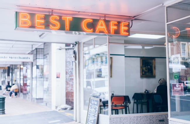 Orange neon sign on the exterior of the cafe.