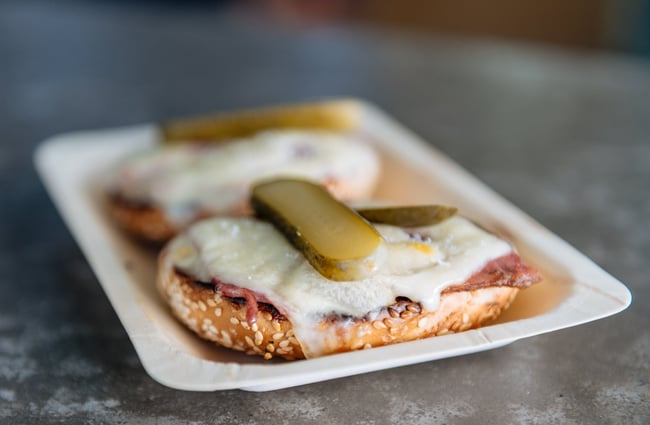Close up of pickles on a bagel.