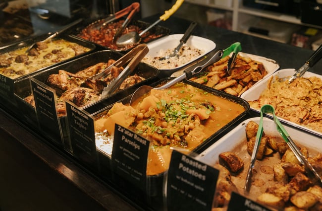 The interior of the warming cabinet at Big Fig with a range of roasted vegetables, protetin and grains.