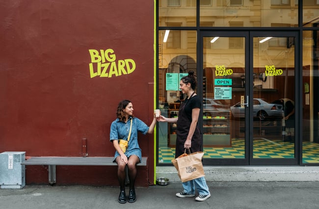 Customer receiving an order outside Big Lizard.