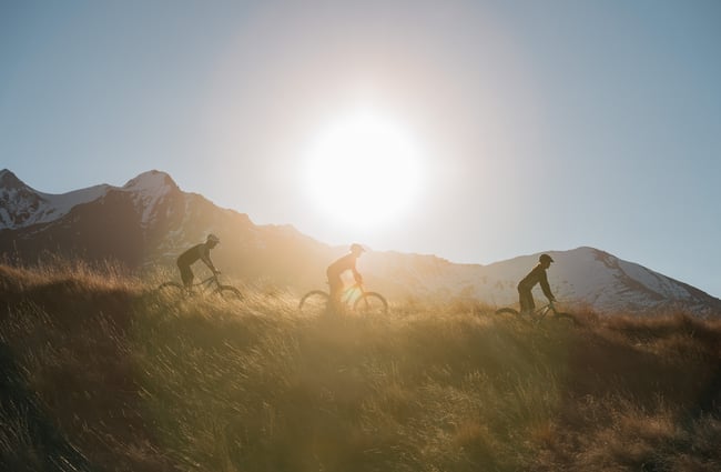 Cycling over grass at sunset.