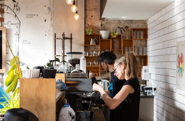 Barista making a coffee behind the machine at Black Betty.