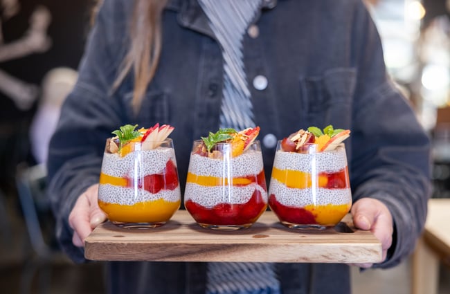 Wait staff holds a tray of breakfast parfaits at Black Betty.