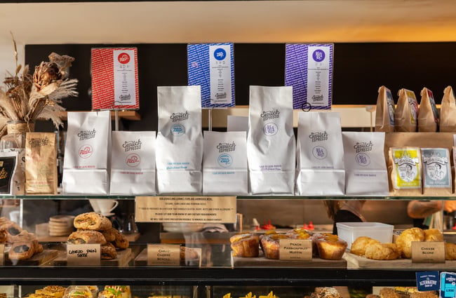 Food cabinet with bags of coffee beans on top at Black Betty.