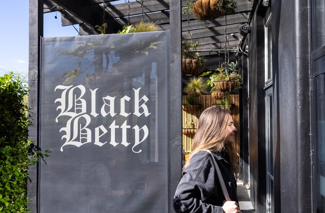 Customer entering the front door of Black Betty.