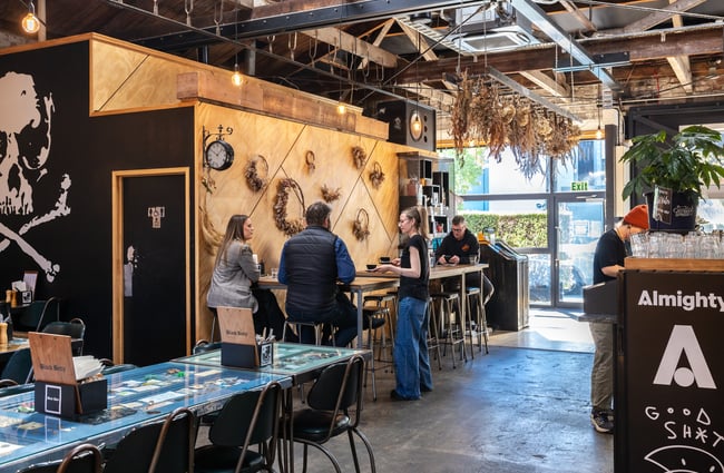 Customers sitting at high tables talking to wait staff at Black Betty.