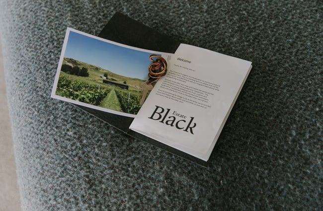 Welcome pack and key to Black Estate Accommodation.