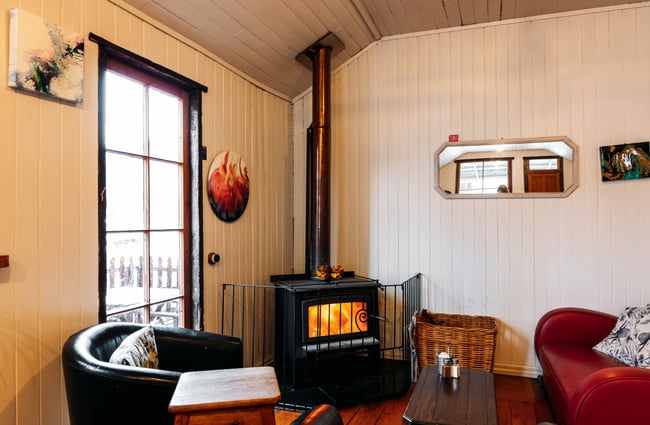 A fireplace in the corner of a cafe.